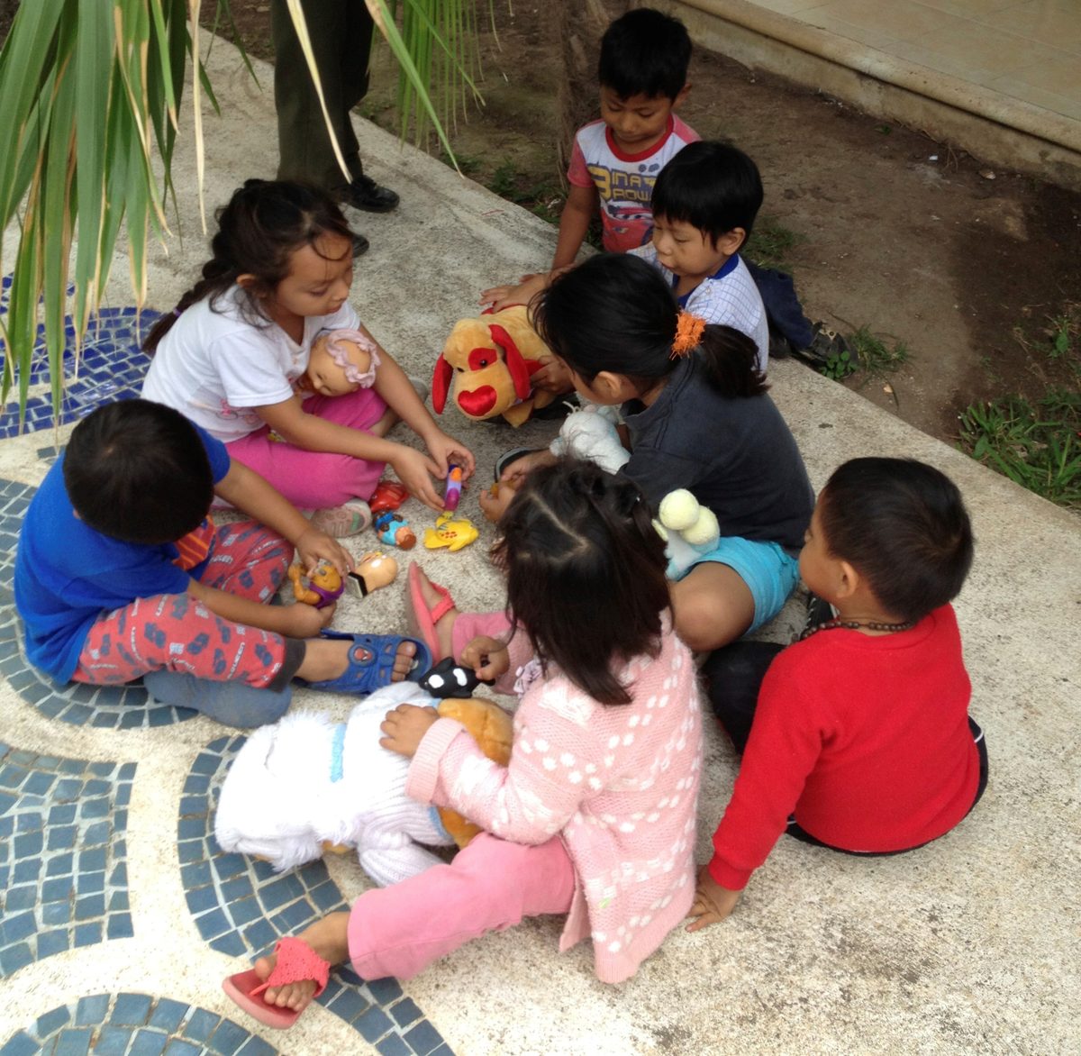 Children in Cancun playing with donated toys and stuffed animals